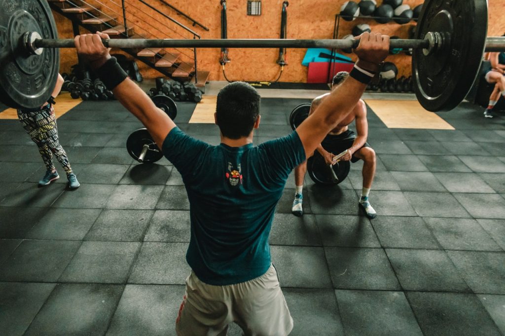 Person lifting barbell indoors