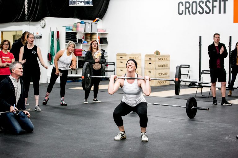 Woman getting last rep in CrossFit Open