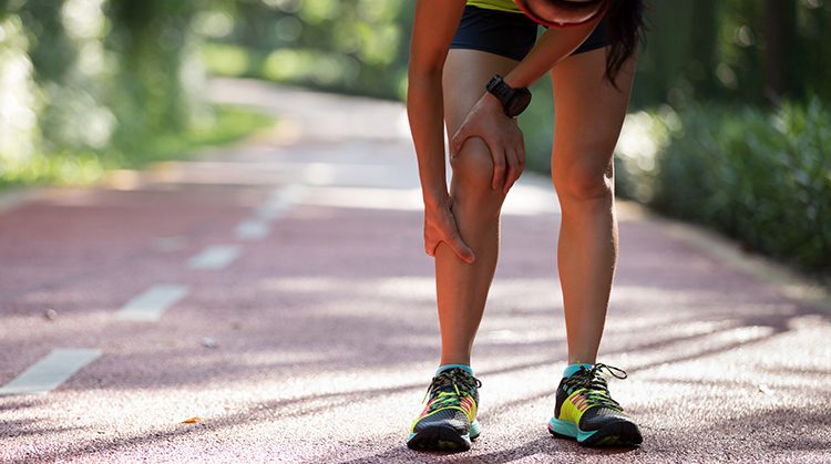 Girl holding shin injury