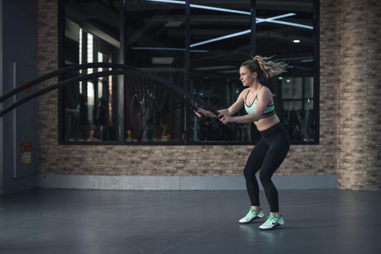 Girl doing battle ropes HIIT