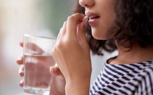 girl taking supplement