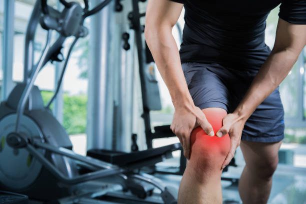 Guy holding inflamed knee