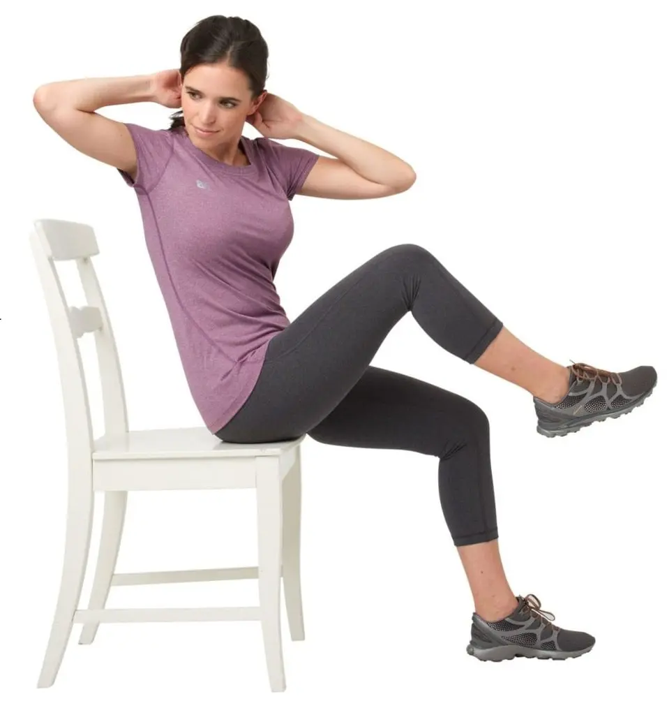 Woman doing knee to elbow in sitting position