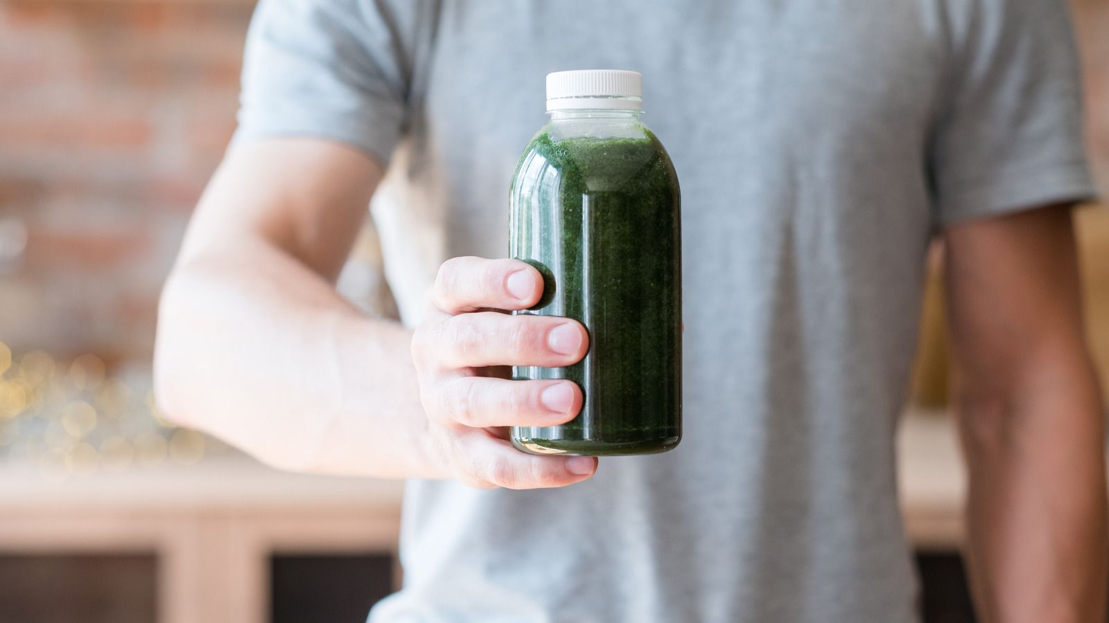 man holding bottled smoothie