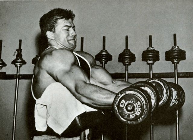 Larry Scott curling on 45 degree preacher bench