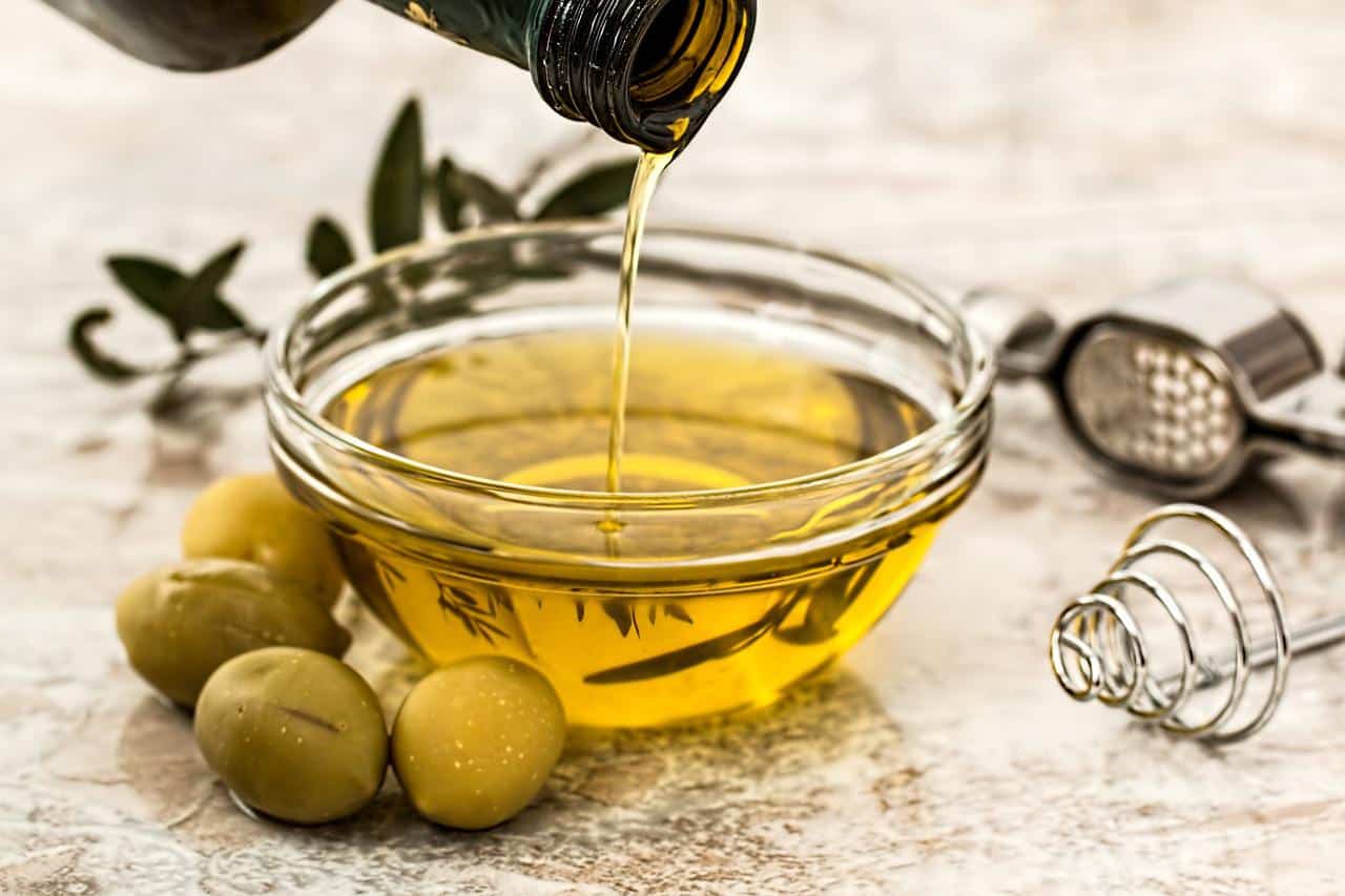 Pouring olive oil into a bowl