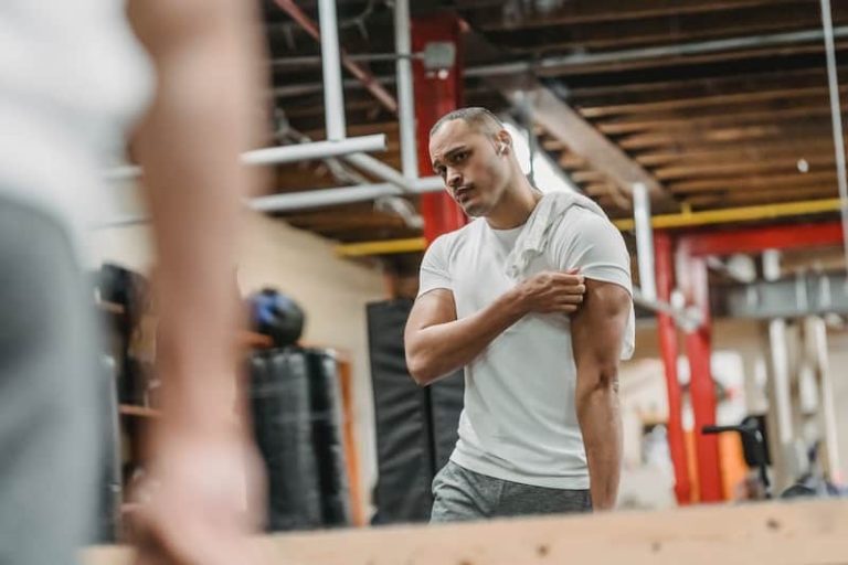 Guy checking his muscles in the mirror