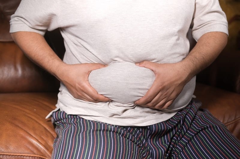 Man holding belly fat