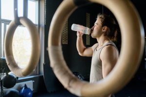 Guy drinking water while working out