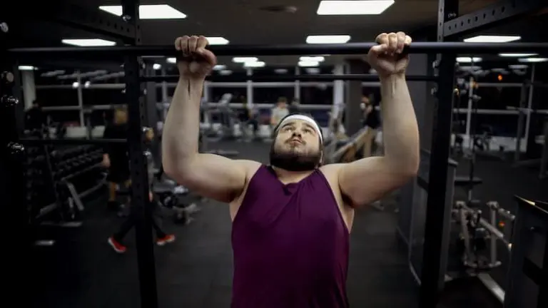 Gym beginner doing a pull up