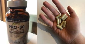 Hand holding probiotic capsules