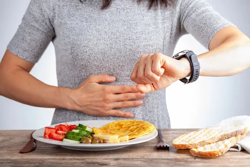 Woman looking at the time while intermittent fasting