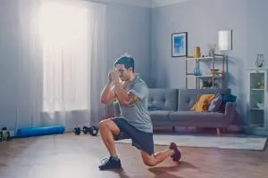 Man doing lunges at home