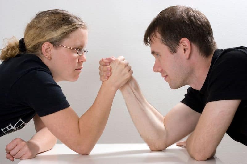 Man and woman arm wrestling