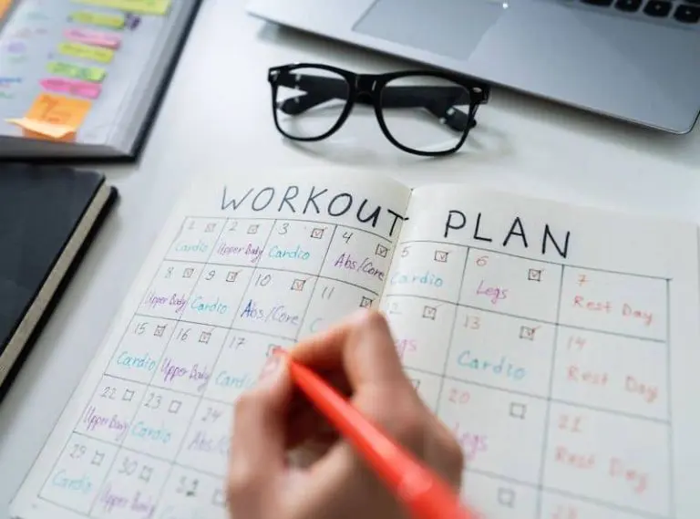 Person writing up a workout plan