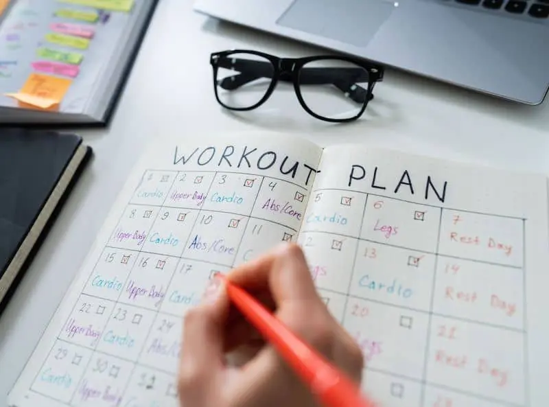 Person writing up a workout plan