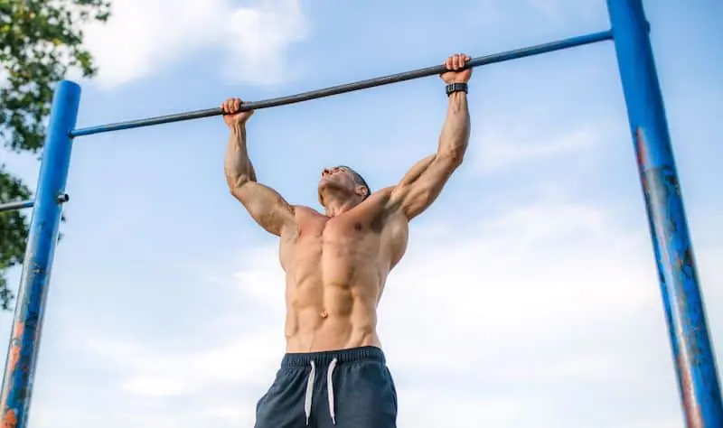 Man doing pull ups outdoors