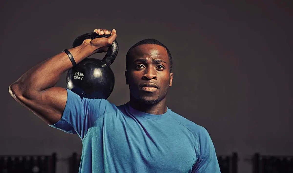 Man doing kettlebell presses