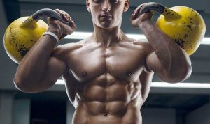 Ripped guy carrying kettlebells