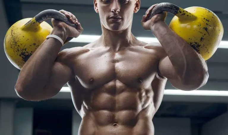 Ripped guy carrying kettlebells