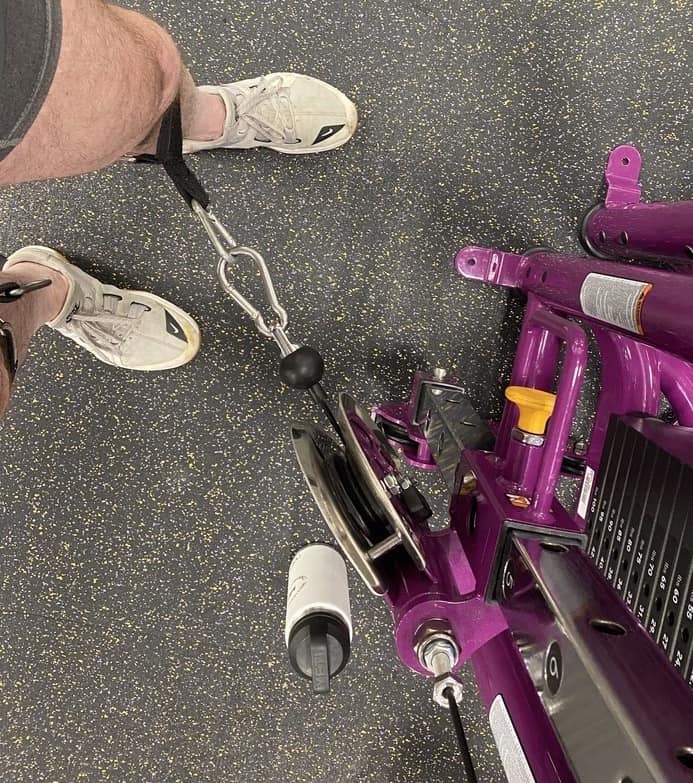 Planet fitness cable hip abduction machine being used by Perry