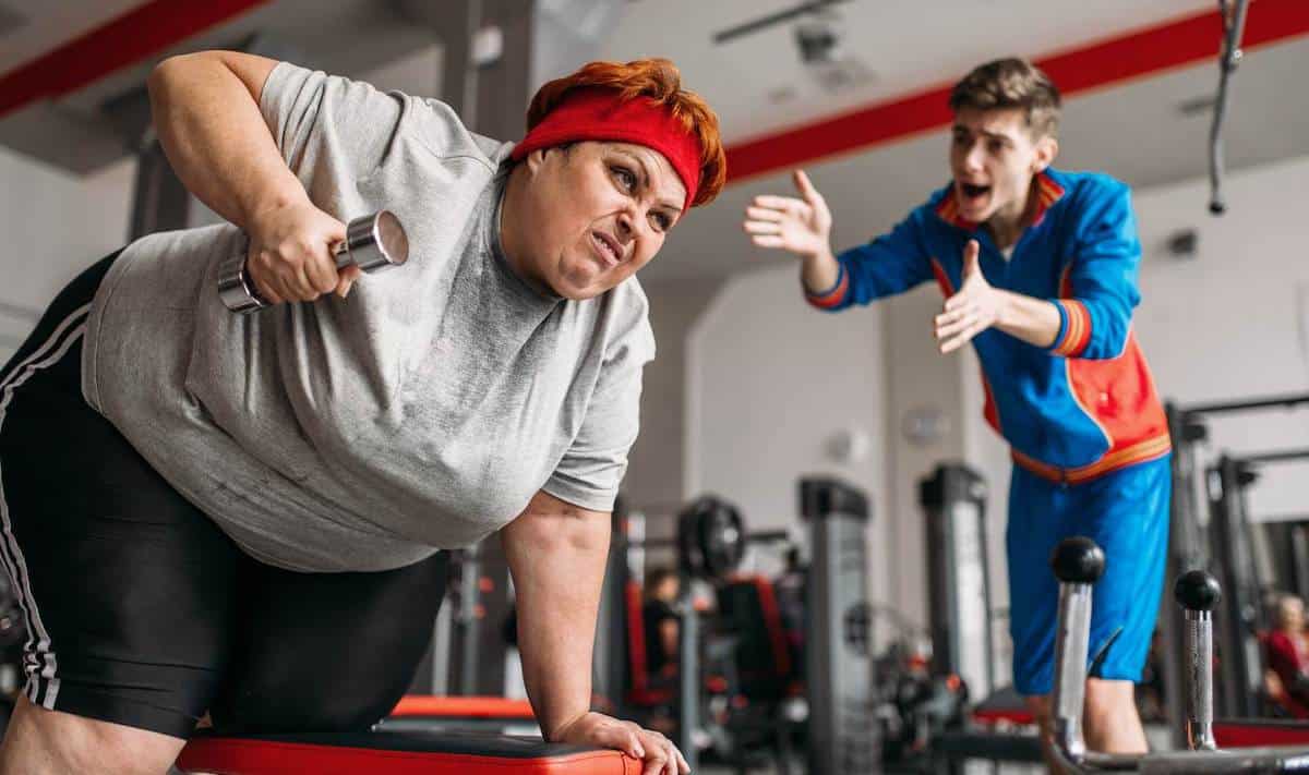 Obese woman doing dumbbell rows