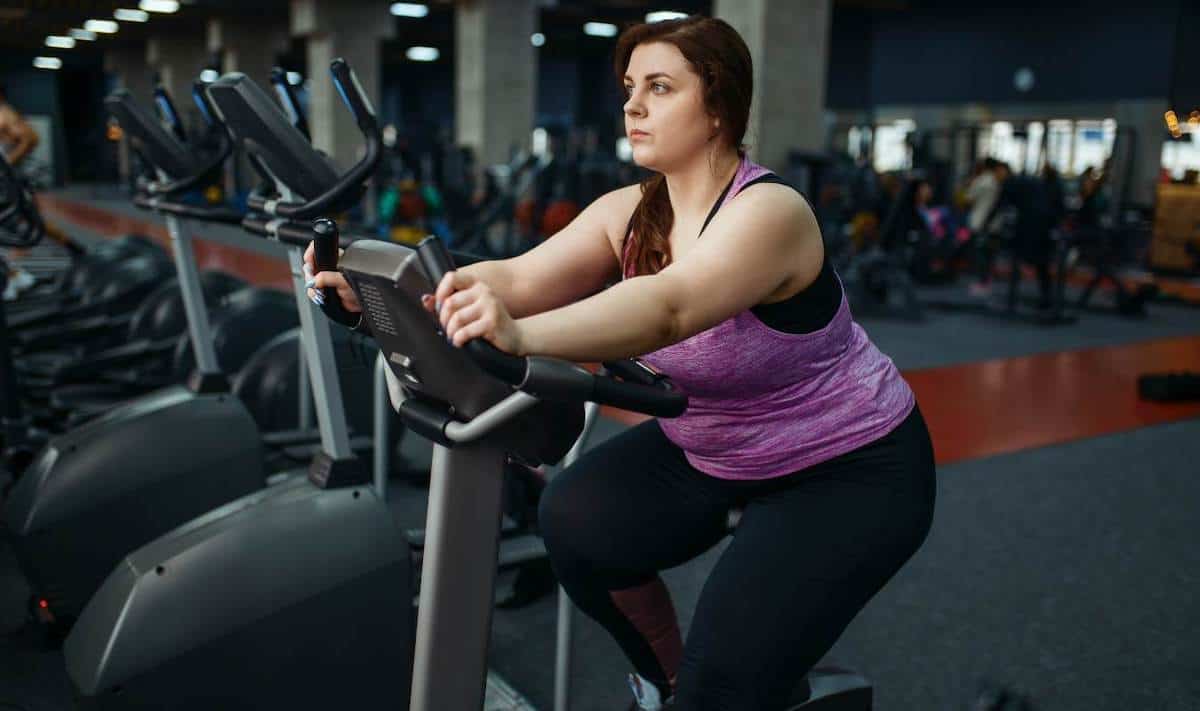 Obese woman on exercise bike