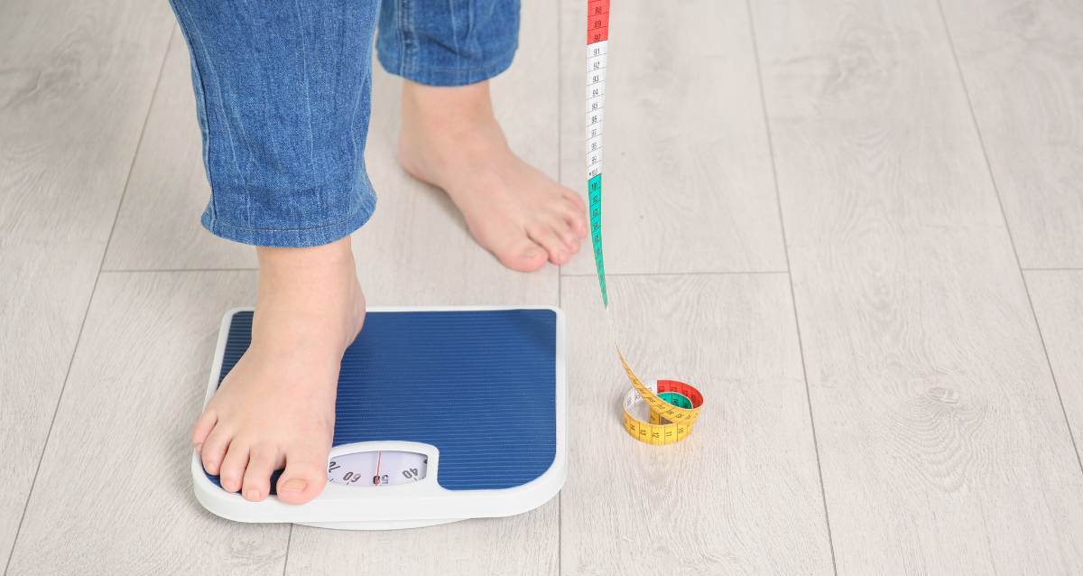 Person stepping onto scales