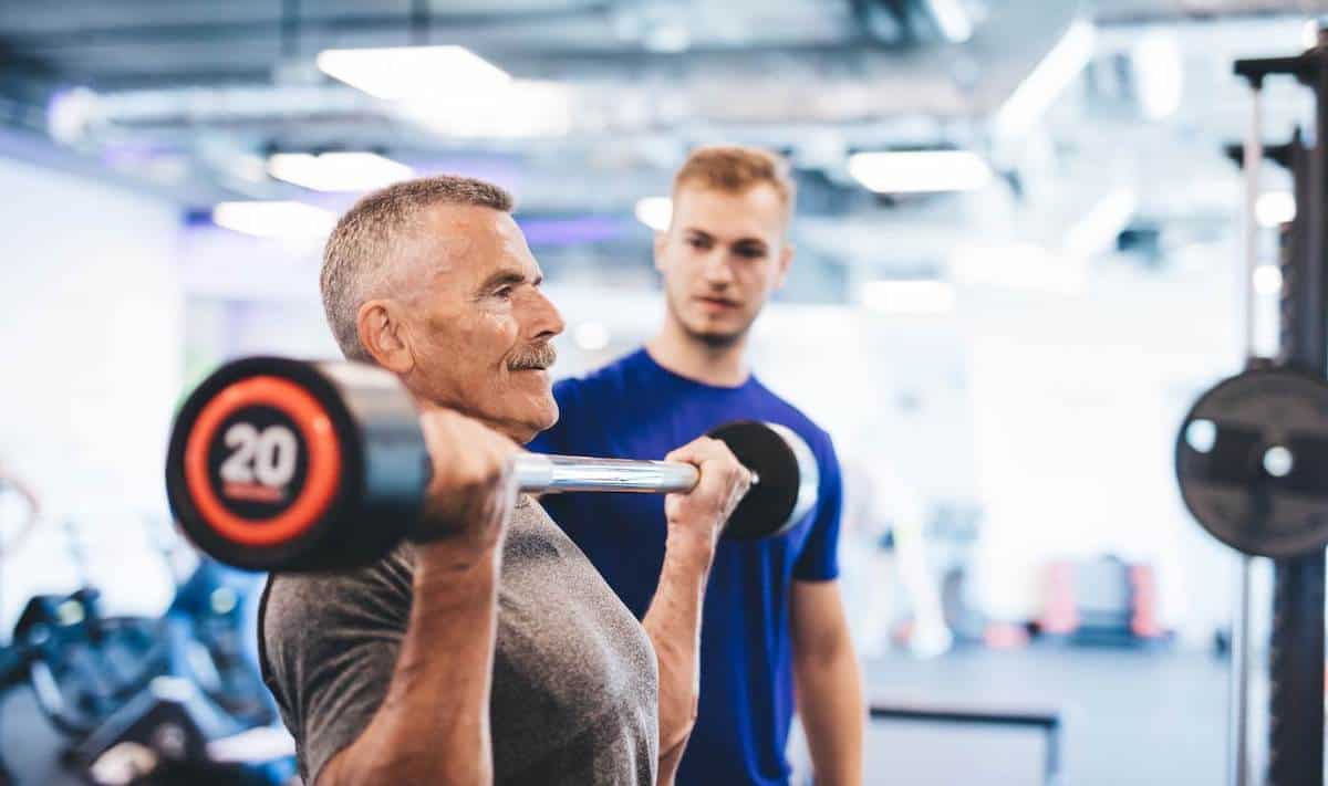 Man being trained bicep curls