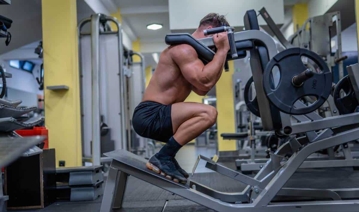 Man using hack squat machine