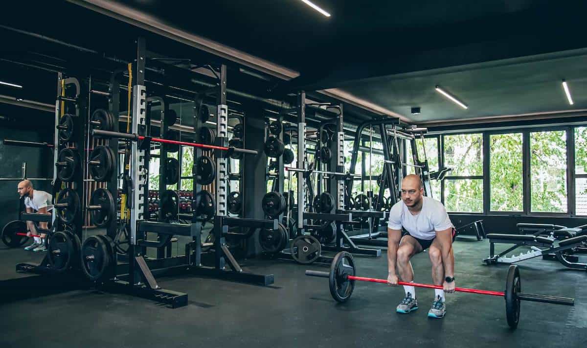 Man working out in a full gym