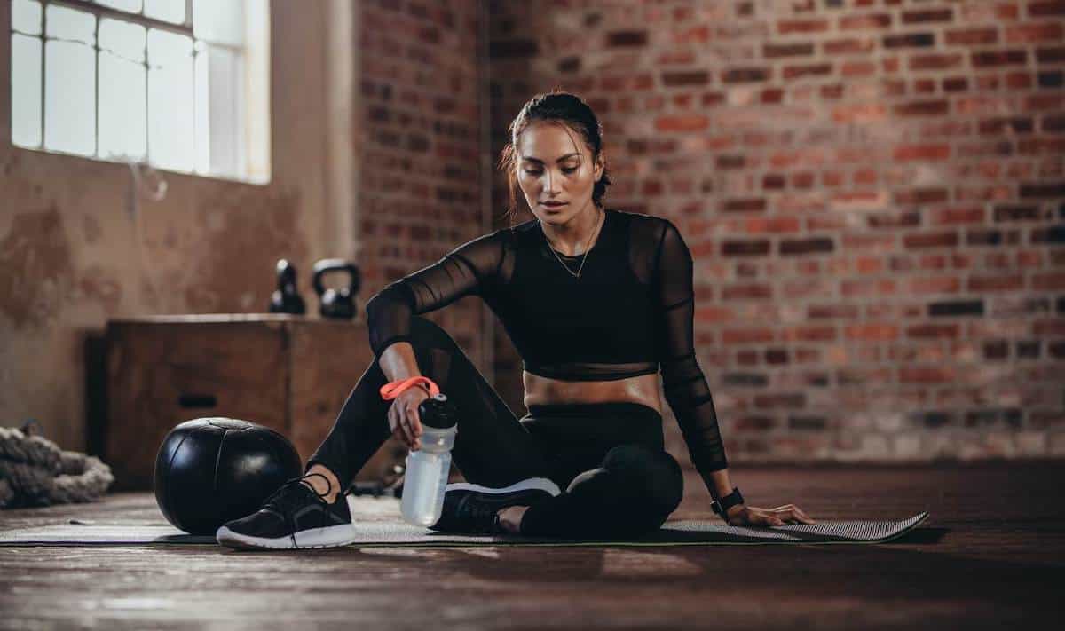 Woman resting after workout set at home