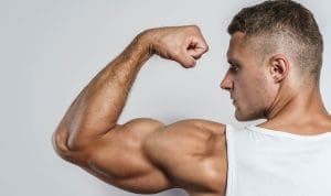 Guy with big arms flexes biceps